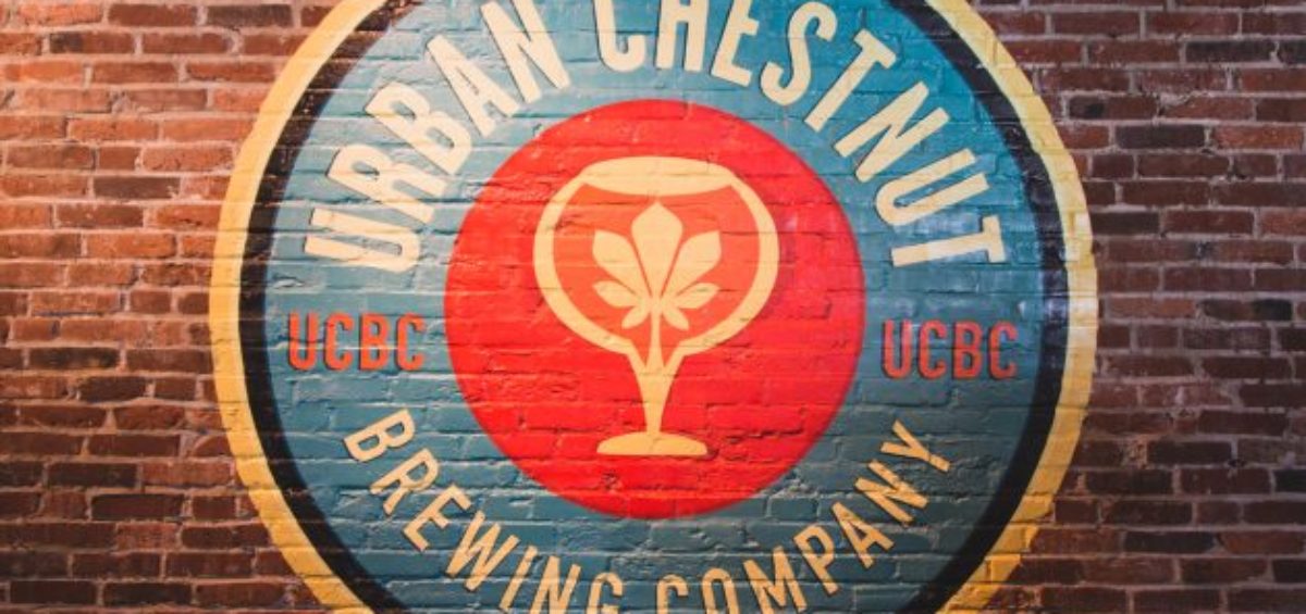 Urban Chestnut Brewing Co. logo painted on brick wall