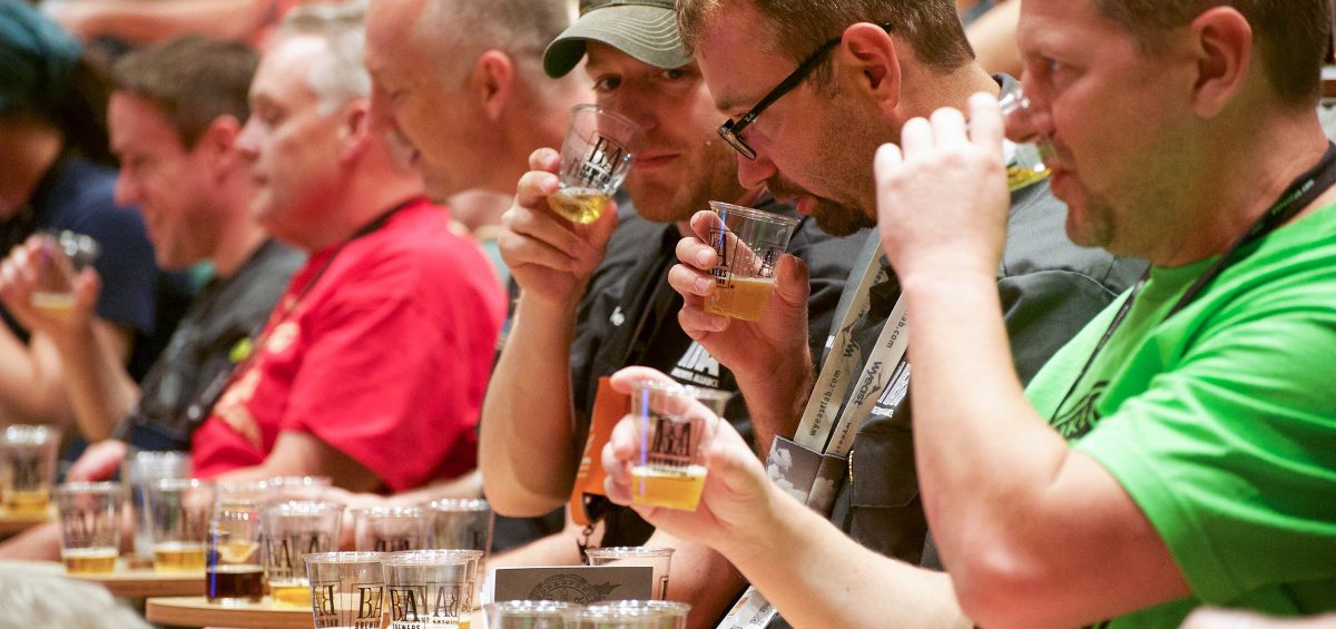 Beer tasting at homebrewcon 2017 with small glasses and line of judges tasting