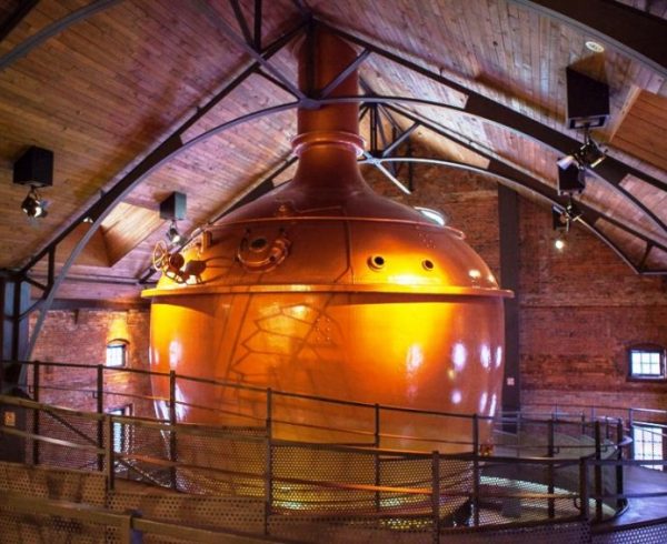 large Sapporo Brewing Company copper brewing vessel in wooden room