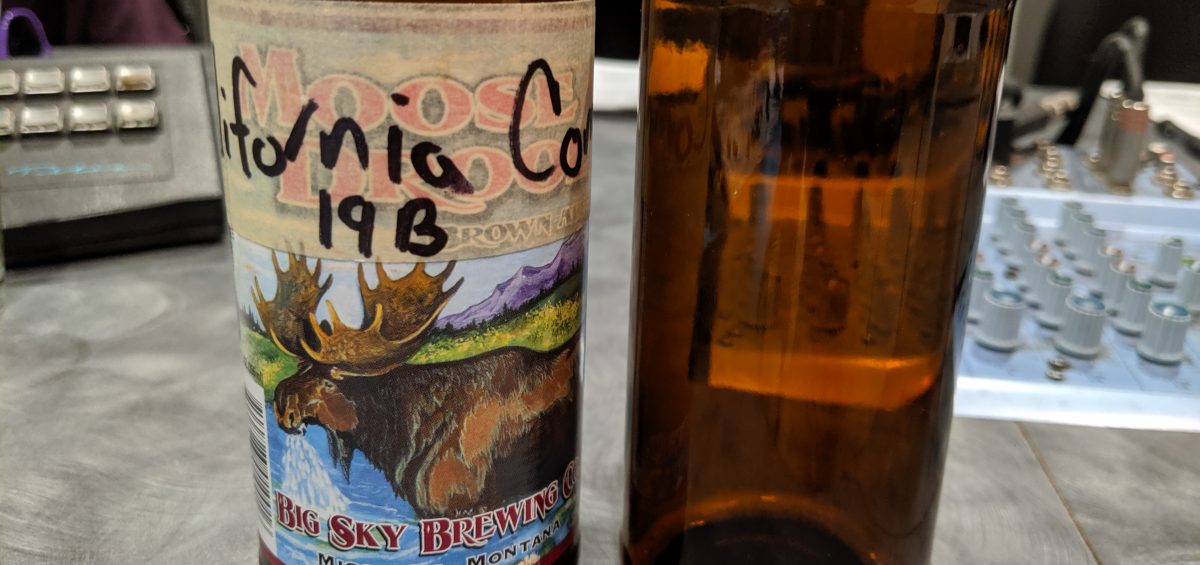 Two empty beer bottles, one with a California Common and one with a Doppelbock, on the Dr. Hombrew podcast