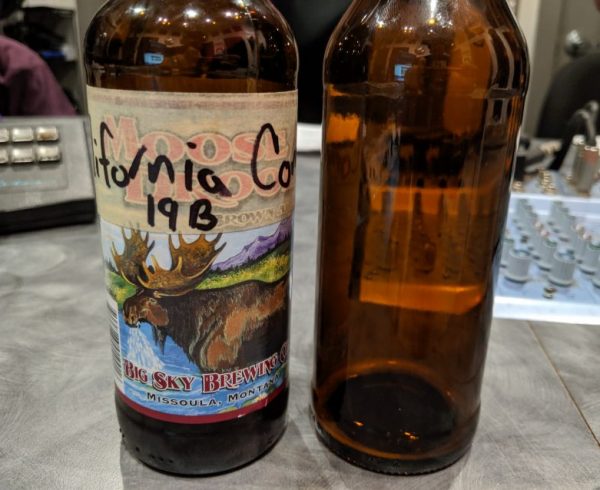 Two empty beer bottles, one with a California Common and one with a Doppelbock, on the Dr. Hombrew podcast