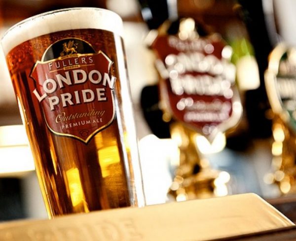 Fullers London Pride Ale in glass with tap handle in background