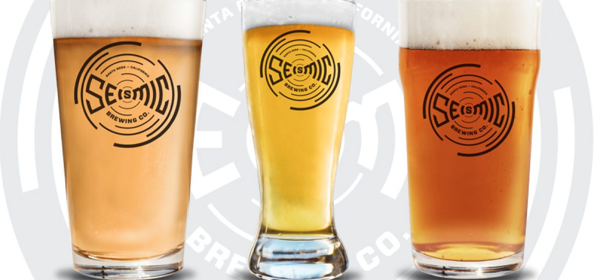 Seismic Brewing Company glasses of beer with logo in background
