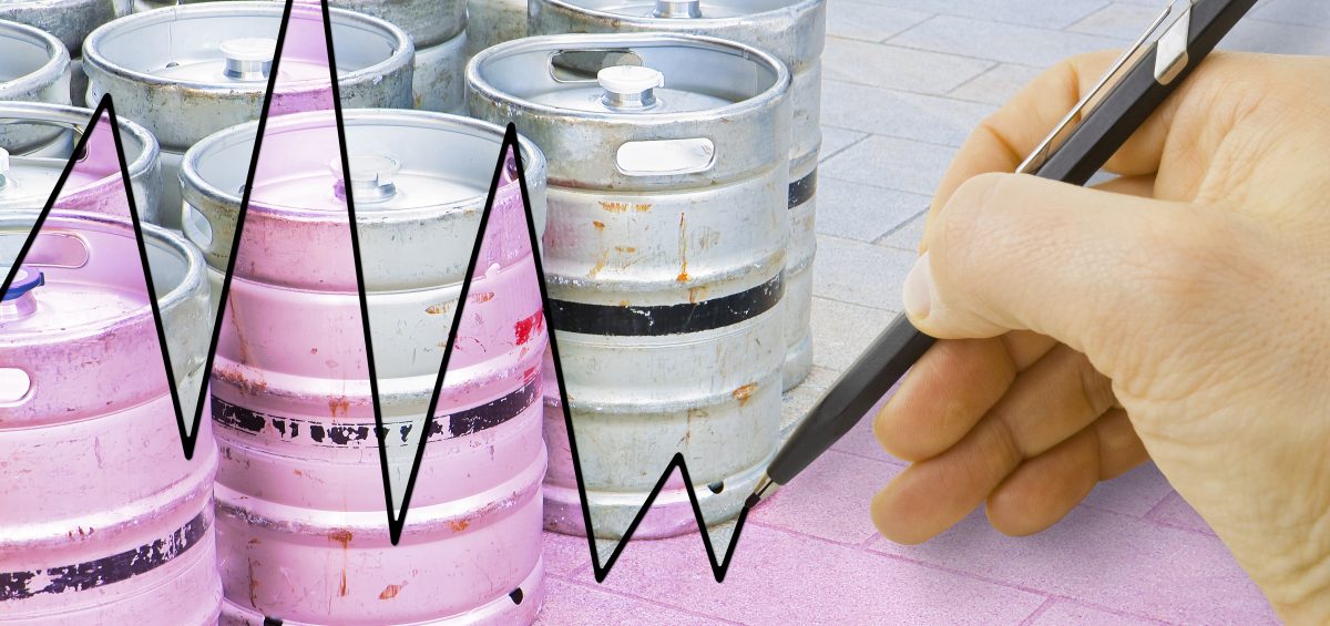 Hand drawing a graph about the trend of beer production with kegs of beer on background