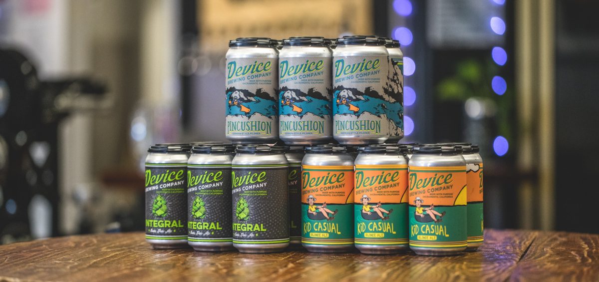 Device Brewing Company cans stacked on table