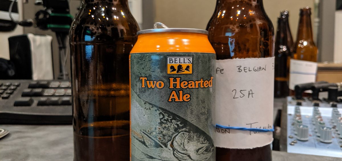 two bottles of homebrewed beer stand next to a can of Bell's Two Hearted ale on Dr. Homebrew