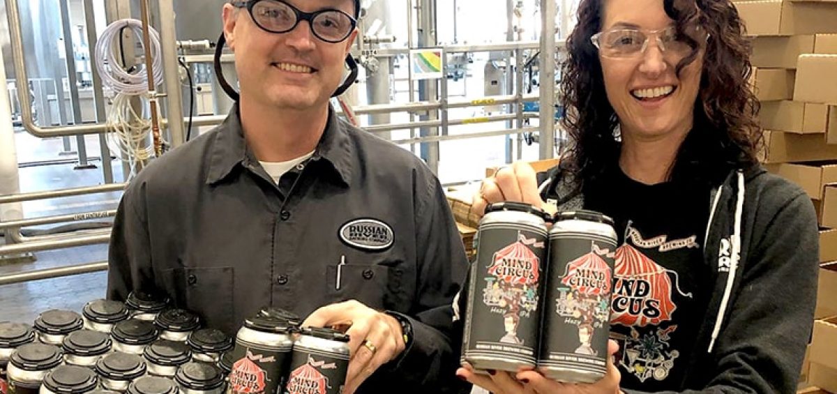 Vinnie & Natalie Cilurzo from Russian River Brewing holding cans of beer