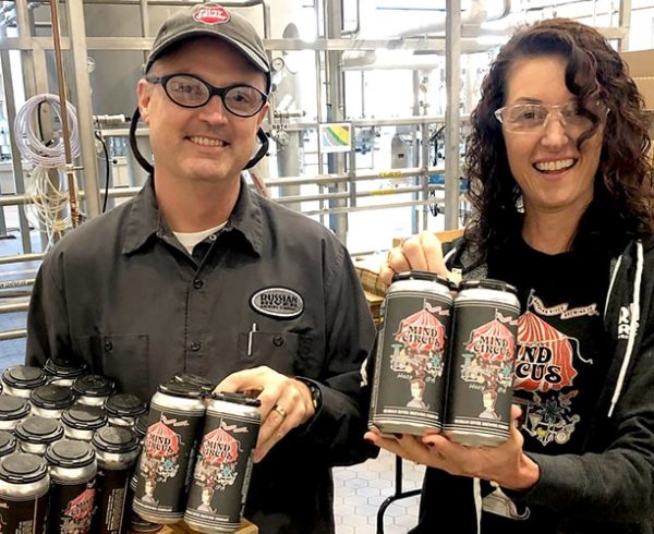 Vinnie & Natalie Cilurzo from Russian River Brewing holding cans of beer